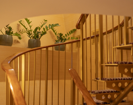 A wooden spiral staircase in a Duplex cabin aboard Fingal Hotel in the Port of Leith.