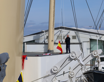 In the distance, standing on top of Britannia, a Maintenance team member is hoisting the dress flags.