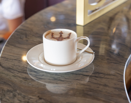 A coffee with a chocolate trident on top of it.