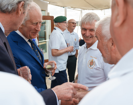 HM The King speaking with smiling Yotties on the Verandah Deck.
