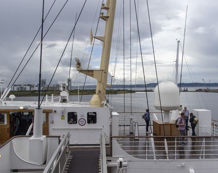 A rainy day at The Bridge on Britannia. Several visitors are listening to their audio guide. 