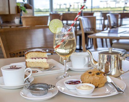 In the Royal Deck Tearoom, a table contains the Tearoom special of Victoria sponge, scone, pot of tea and coffee. 