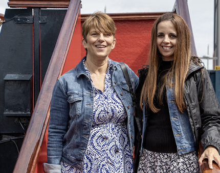 Two smiling visitors pose on the Royal Brow at Britannia. 