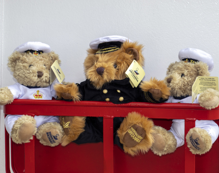 Two Yottie teddy bears wearing white Yottie uniforms and a cuddly Captain bear. 