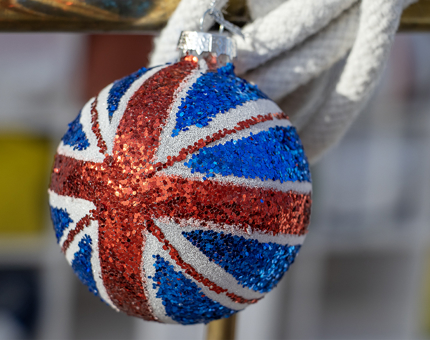 A glitter-covered Union Jack Christmas bauble decoration.