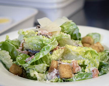 A dish of Caesar salad.