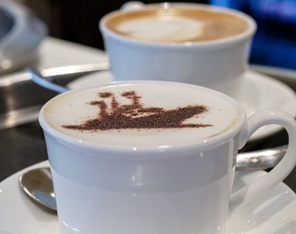 A cappuccino with a chocolate stencil of the outline of Britannia on top.