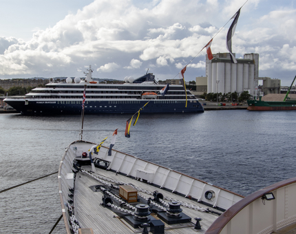 The bow of the Royal Yacht with a modern cruise liner in the background at Leith.