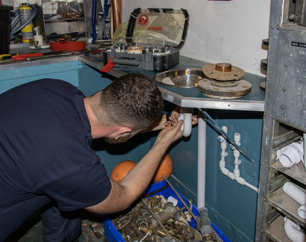 A man replacing a trap in a sink.