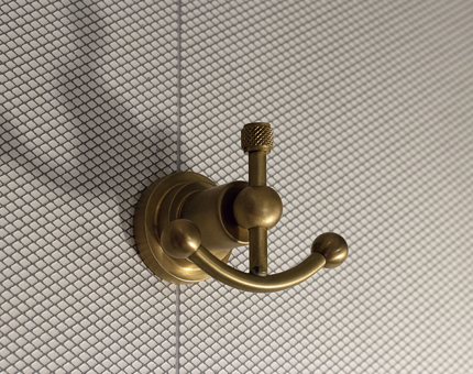 A brass-coloured ornamental anchor hook. 
