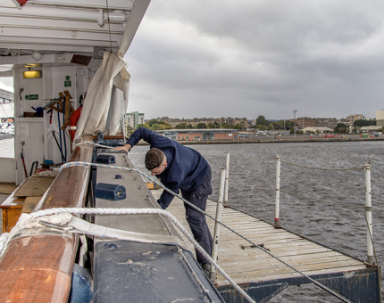 Steven sanding Britannia’s starboard shipside.