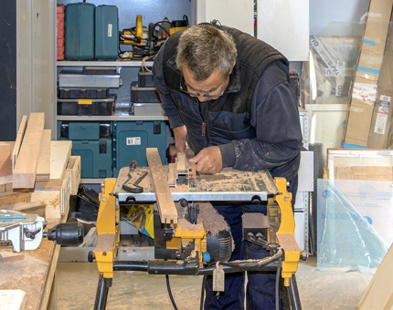 Gary cutting wood for the events plinth.