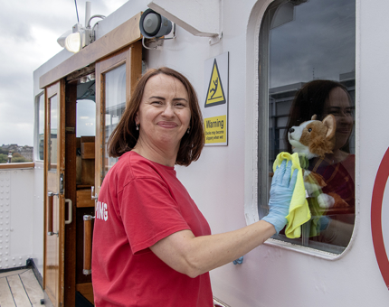 A Housekeeper woman polishing a window on Britannia's Bridge. 