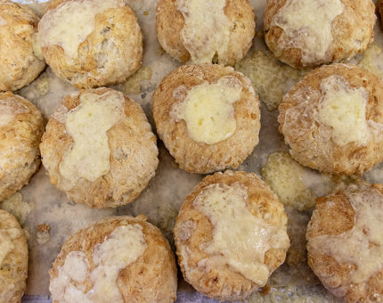 A tray of fresh out of the oven cheese scones. 
