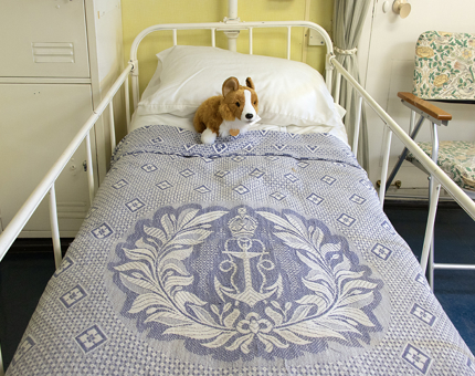 A cuddly Corgi soft toy on a hospital bed in the onboard Sick Bay. 