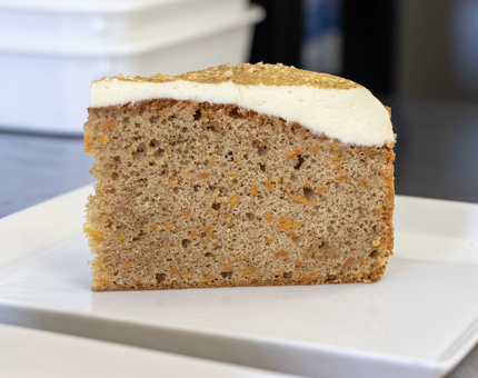 A slice of carrot cake on a plate. 