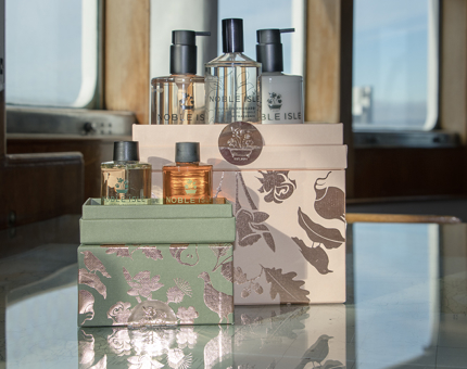 Two Christmas gift sets from luxury bath and body company, Noble Isle. 