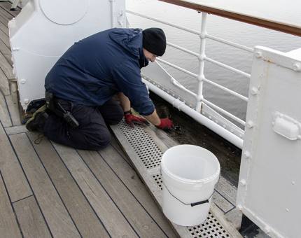 A man cleaning out the scuttles.