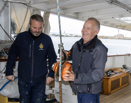Two men from the Maintenance Team working on Britannia's Shelter Deck. 