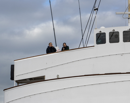 The Bridge of Britannia where two visitors are looking out while listening to audio guides. 