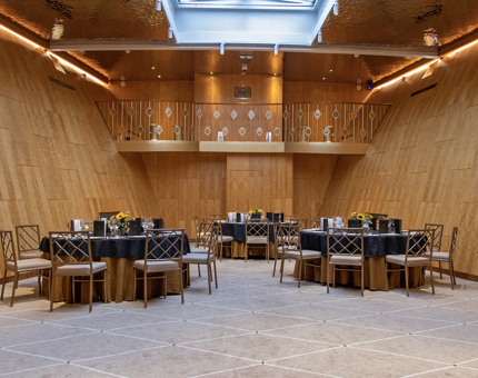 In Fingal's wood panelled Ballroom, three round tables are set for dinner. 