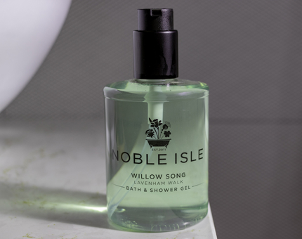 A bottle of green-hued Noble Isle shower gel. 