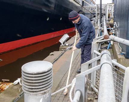 A man tending to weeding on the Quayside. 