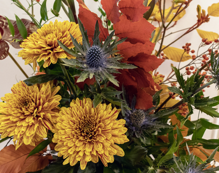 A floral display of yellow and orange flowers. 