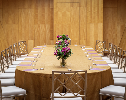 Fingal's wood-panelled Ballroom with a long table set with flowers and glasses.