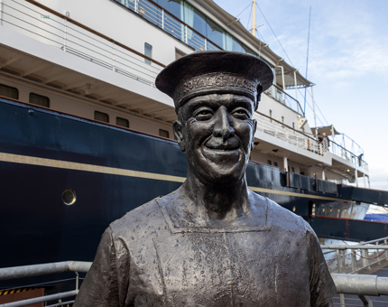 Statue of a former Royal Yachtsmen outside the ship The Royal Yacht Britannia