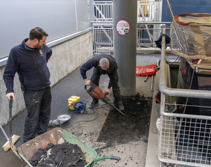 Members of the Maintenance Team are digging out the foundation around the Royal Barge. 