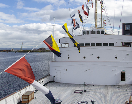 The dress flags over an aerial shot of Britannia. 