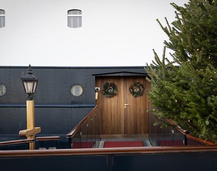 The entrance brow to Fingal with a Christmas tree at the foot of the brow and two wreaths hanging on the front doors. 