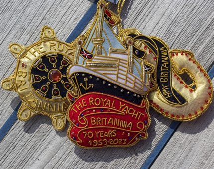 Britannia embroidered hanging decorations including a ship's wheel, Britannia ship and golden anchor.