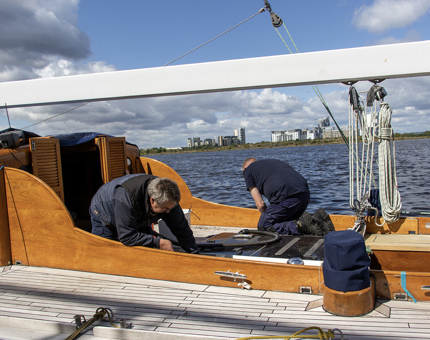 Two members of the Maintenance team working on the refurbishment of Royal Racing Yacht Bloodhound. 
