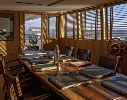 The Bridge at Fingal with large dining table and leather bound logbooks. 