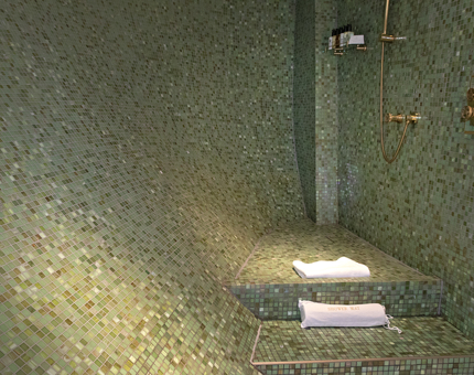 A green-mosaiced bathroom in a Fingal cabin.