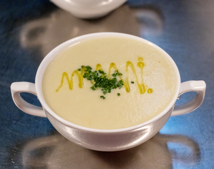 A two-handled bowl of Cullen Skink soup.