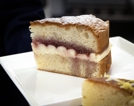 A large slice of Victoria sandwich cake.
