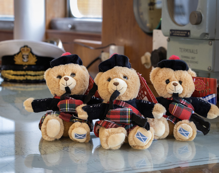 Three cuddly teddy bear bagpipers. 