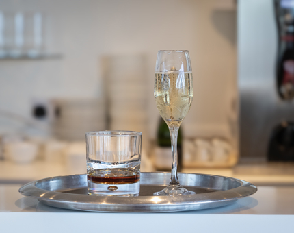 A glass of champagne on a tray 