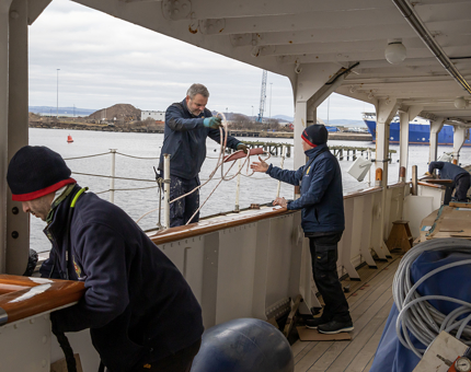 Man in blue coat painting