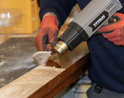A more detailed look as the heat gun removes varnish.