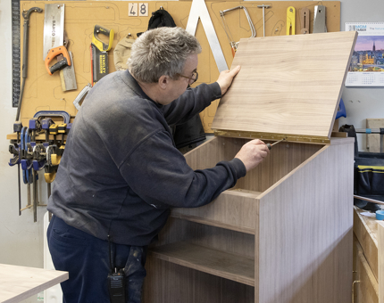 The man assembling the podium for the Tearoom.