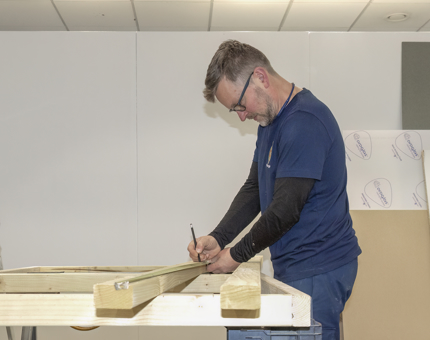 A man from the Maintenance Team measuring make a new handset counter. 