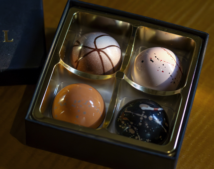 A box containing individually hand-crafted chocolates.