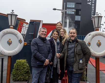 A group of visitors pose with their audio guided tour handsets at the Royal Brow at Britannia. 