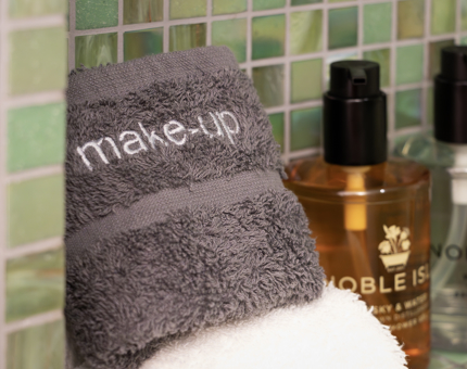 Noble Isle body washes and a towel in a cabin bathroom on Fingal.