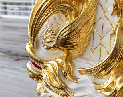 A detail of the gold leaf on the compass binnacle.