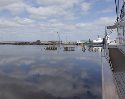 A view across the Port of Leith and reflections in the water next to Britannia. 
